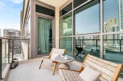 an apartment balcony with two chairs and a table at GuestReady - Glamorous stay in Dubai Marina in Dubai