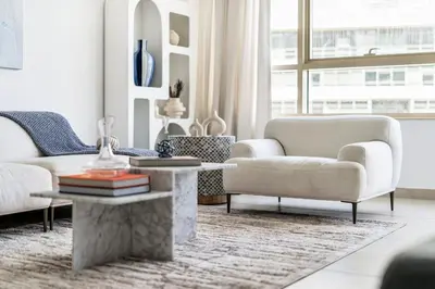 a living room with white furniture and a large window at GuestReady - Glamorous stay in Dubai Marina in Dubai