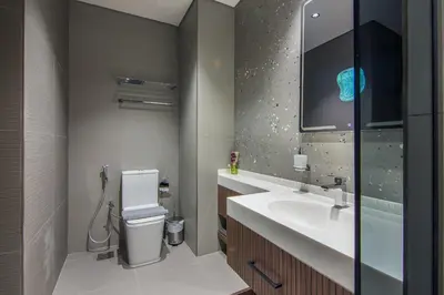 a bathroom with a sink and a toilet and a mirror at MBL Royal, JLT- 1-BR Apartment with Lake View in Dubai