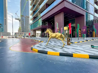 a statue of a horse in front of a building at MBL Royal, JLT- 1-BR Apartment with Lake View in Dubai
