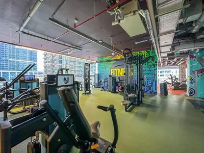 a gym with cardio equipment in a large room at MBL Royal, JLT- 1-BR Apartment with Lake View in Dubai