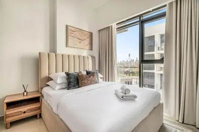 a bedroom with a large bed with a large window at GuestReady - Contemporary retreat at Azizi Gardens in Dubai