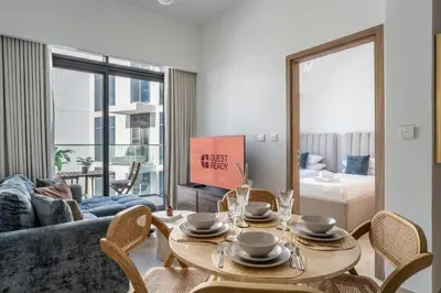 a living room with a table and chairs and a couch at GuestReady - Contemporary retreat at Azizi Gardens in Dubai