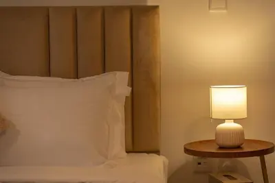 a bed with a lamp on a table next to it at Luxury Living Brand New 1 Bed Downtown Dubai Southridge in Dubai