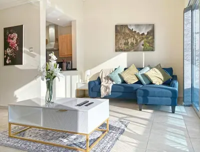 a living room with a blue couch and a coffee table at ONE Bedroom with Sea view in Dubai Marina - Z1106 in Dubai