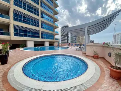 a large swimming pool in front of a building at ONE Bedroom with Sea view in Dubai Marina - Z1106 in Dubai