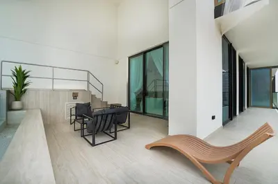 a balcony with a table and chairs in a building at EasyGo- Luxury, Private Pool and Serene Location in Dubai