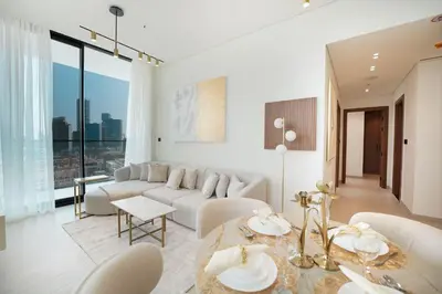 a living room with a white couch and a table at EasyGo- Luxury, Private Pool and Serene Location in Dubai