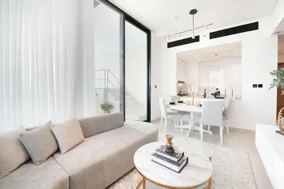 a living room with a couch and a table at EasyGo- Luxury, Private Pool and Serene Location in Dubai