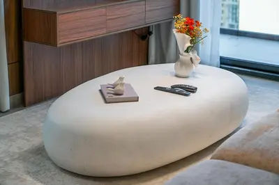a round white table in a living room with a vase at EasyGo- Luxury, Private Pool and Serene Location in Dubai