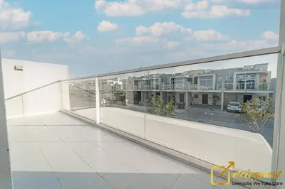 a balcony with a view of a parking lot at Tranquil 3br Townhouse in Damac Hills2 by deleguest in Dubai