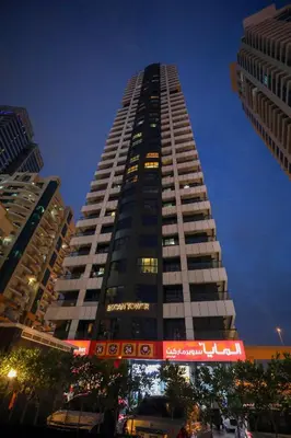 a tall building with a red sign on it at LUXURY 1BED MARINA VIEW JBR BEACH POoL PARKING in Dubai