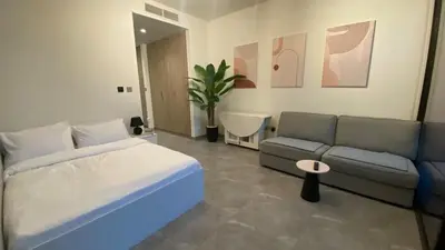 a bedroom with a bed and a couch at Sky Burj Khalifa View in Dubai