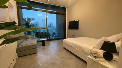 a bedroom with a bed and a large window at Sky Burj Khalifa View in Dubai
