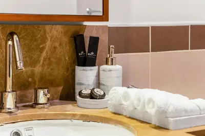 a bathroom counter with a sink with toothbrushes and towels at Lux Burj and Fountain views Steps from Dubai Mall in Dubai
