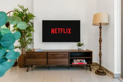 a living room with a tv with the netflix sign on it at Lux Burj and Fountain views Steps from Dubai Mall in Dubai