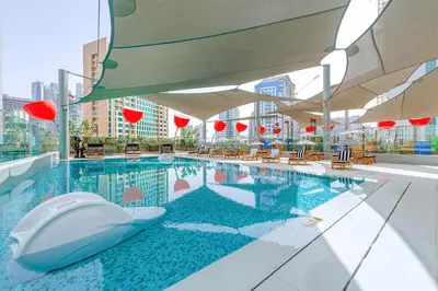 a swimming pool with a toilet in the middle of a building at Chic Studio 5 Min Walk to Dubai Mall & Burj in Dubai