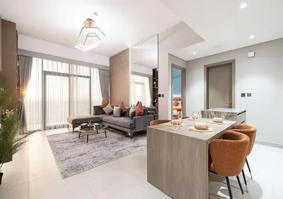 a living room with a couch and a table at Chic 1-Bed Apartment with Exclusive Amenities JVC in Dubai
