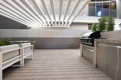 a kitchen with a stove and a counter top at Chic 1-Bed Apartment with Exclusive Amenities JVC in Dubai