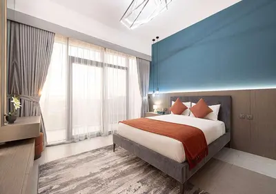 a hotel room with a bed and a large window at Chic 1-Bed Apartment with Exclusive Amenities JVC in Dubai