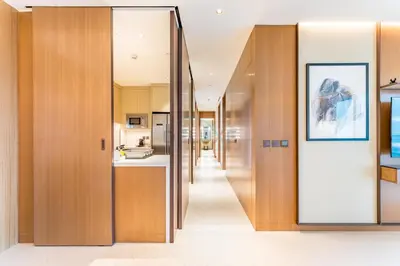 a hallway with wooden walls and a glass door at Overlooking Burj Khalifa and Fountain Views from Living to Bedrooms, The Address Residences Dubai Opera Tower 2, Downtown Dubai by Deluxe Holiday Homes in Dubai