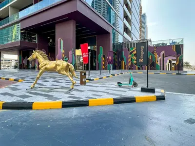 a statue of a horse running in front of a building at MBL Royal, JLT- Two Bedroom with Lake View in Dubai