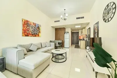 a living room with a couch and a table at Modern Studio Retreat in Sports City Dubai in Dubai
