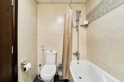 a bathroom with a toilet and a bath tub at Modern Studio Retreat in Sports City Dubai in Dubai