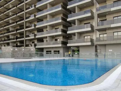 an empty swimming pool in front of a building at Modern Studio Retreat in Sports City Dubai in Dubai