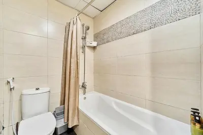 a bathroom with a toilet and a bath tub at Modern Studio Retreat in Sports City Dubai in Dubai