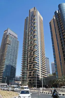 two tall buildings with cars in front of them at HAVN - 1 Bed in Dubai Marina, 5mins walk to JBR in Dubai