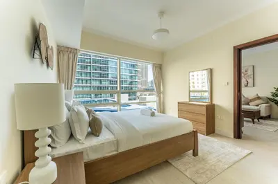 a bedroom with a large bed and a large window at HAVN - 1 Bed in Dubai Marina, 5mins walk to JBR in Dubai