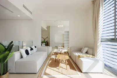 a living room with white couches and a table at Livbnb-Tranquil Family Home, 4BR with Maid's Room in Dubai