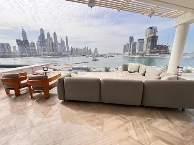 a living room with a couch and a view of a city at Daniels 4BR at Five Palm With Private Pool in Dubai