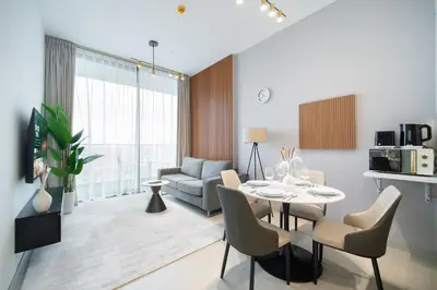 a living room with a table and a couch at SettlerHomes - Chic JVC Cityview Near Heart of Dubai in Dubai