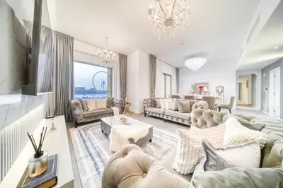 a living room filled with furniture and a chandelier at THE JBR Grand Luxury Sea View 4 BEDROOM in Dubai