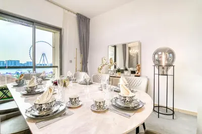 a dining room with a table and a large window at THE JBR Grand Luxury Sea View 4 BEDROOM in Dubai