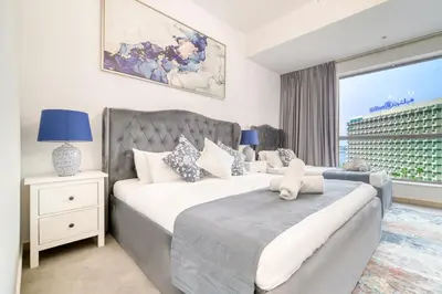 a bedroom with two beds and a window at THE JBR Grand Luxury Sea View 4 BEDROOM in Dubai