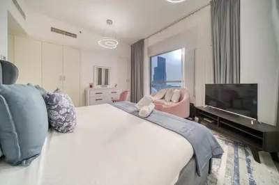 a bedroom with a large bed and a television at THE JBR Grand Luxury Sea View 4 BEDROOM in Dubai