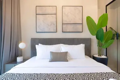 a bedroom with a large bed with white pillows at Upscale 2BR in Lively Building in Dubai