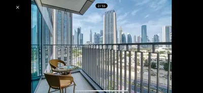 a balcony with two chairs and a view of a city at Downtown holiday home in Dubai
