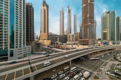 a highway in a city with many tall buildings at Cozy Studio Steps from Dubai Mall & Burj Khalifa in Dubai