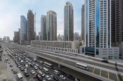 a busy highway in a city with tall buildings at Cozy Studio Steps from Dubai Mall & Burj Khalifa in Dubai