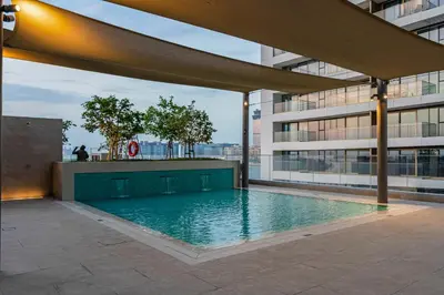 a swimming pool on the side of a building at Private Beach-Infinity Pool-Lux Beachfront in Dubai