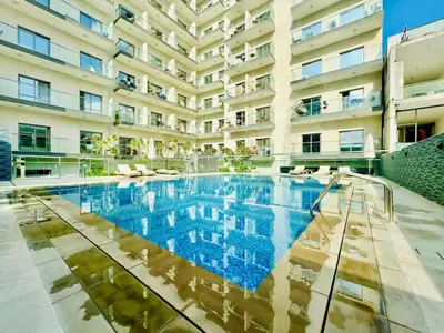 a swimming pool in front of a building at Bab al qarya in Dubai