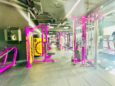 a gym with pink equipment in a room at Bab al qarya in Dubai