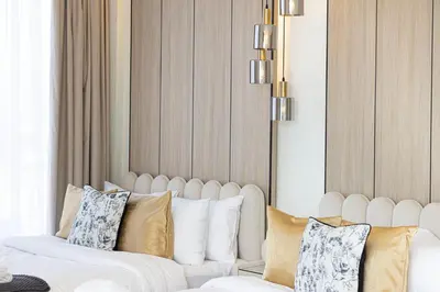 a living room with a white couch and pillows at Sky High Luxury, Grande Signature, Burj Khalifa View, 5 minute walk to Dubai Mall in Dubai