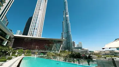 a pool in the middle of a city with tall buildings at Sky High Luxury, Grande Signature, Burj Khalifa View, 5 minute walk to Dubai Mall in Dubai