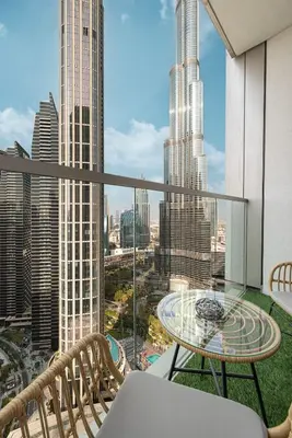 a balcony with a table and chairs and a view of the city at Sky High Luxury, Grande Signature, Burj Khalifa View, 5 minute walk to Dubai Mall in Dubai