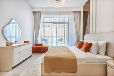 a bedroom with a large bed and a large window at Luxury 1BR Haven Chic & Cozy Stay in JVC in Dubai